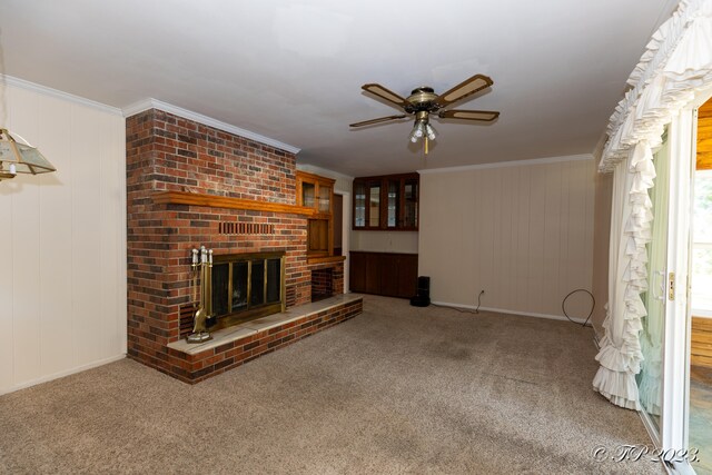 unfurnished living room with ornamental molding and carpet