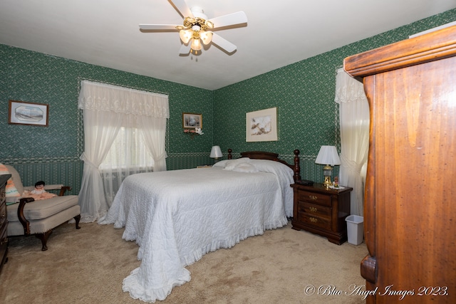 bedroom featuring ceiling fan and light carpet