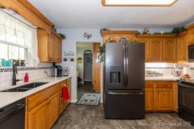 kitchen featuring tasteful backsplash, black appliances, and sink