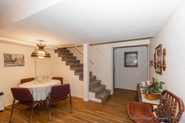 4565 State Route Cc, West Plains, MO 65775 - dining space featuring stairway, visible vents, wood finished floors, and a textured ceiling