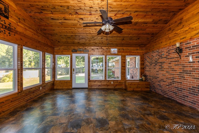 unfurnished sunroom featuring wood ceiling, vaulted ceiling, and ceiling fan