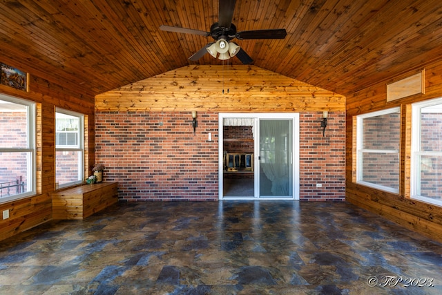 unfurnished sunroom featuring lofted ceiling, ceiling fan, and wood ceiling