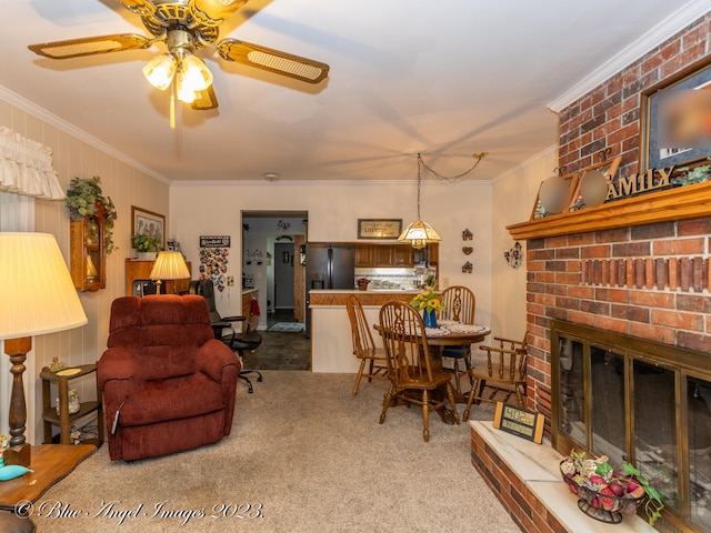 living room featuring ornamental molding, a brick fireplace, ceiling fan, and carpet floors