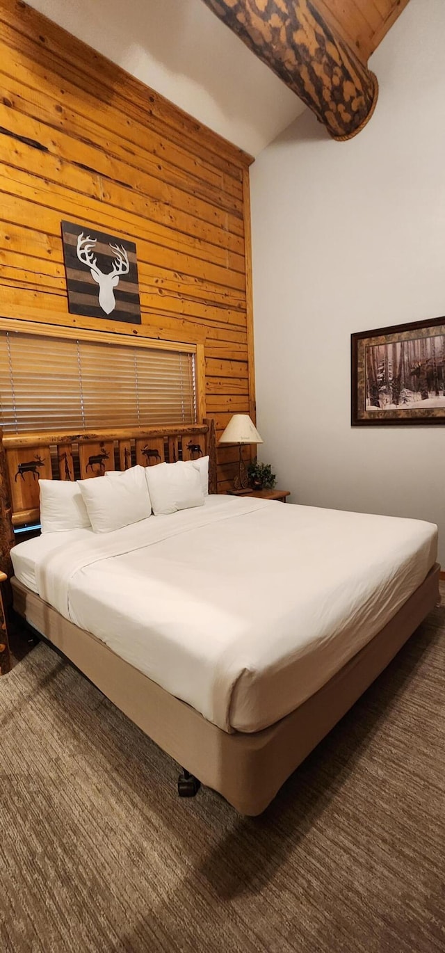 bedroom with wood walls and carpet flooring