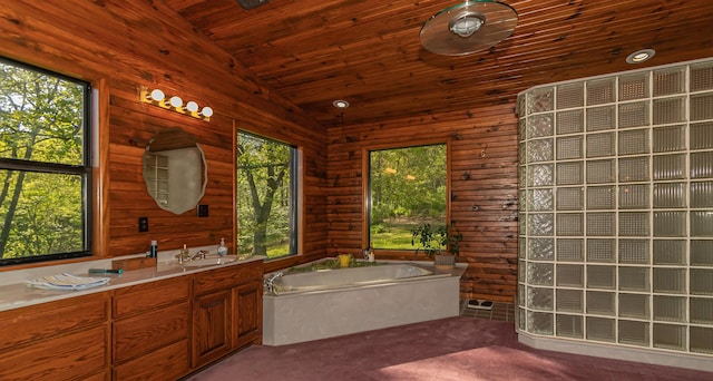 bathroom with a bath, vaulted ceiling, wood ceiling, wooden walls, and vanity