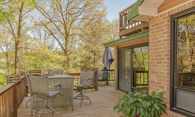 deck with outdoor dining area