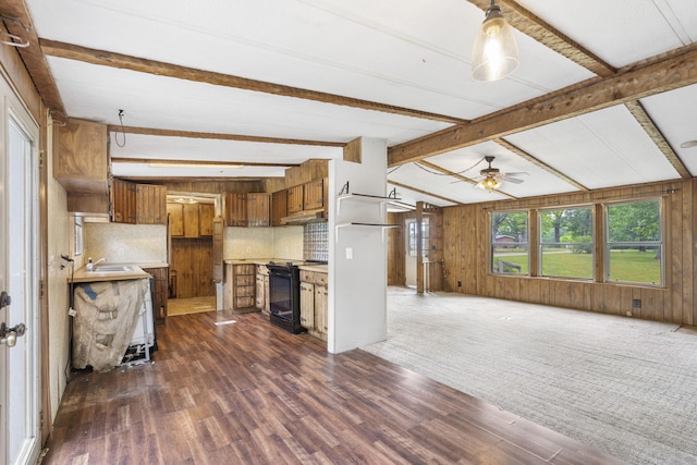 kitchen with ceiling fan, wood walls, dark wood-type flooring, lofted ceiling with beams, and black range oven