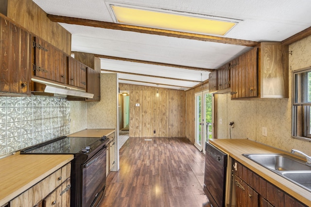 kitchen featuring black appliances, sink, dark hardwood / wood-style flooring, vaulted ceiling with beams, and wood walls