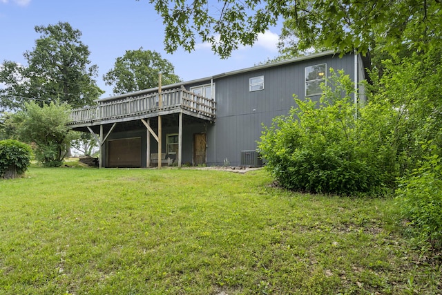 back of house featuring a yard, central AC, and a deck