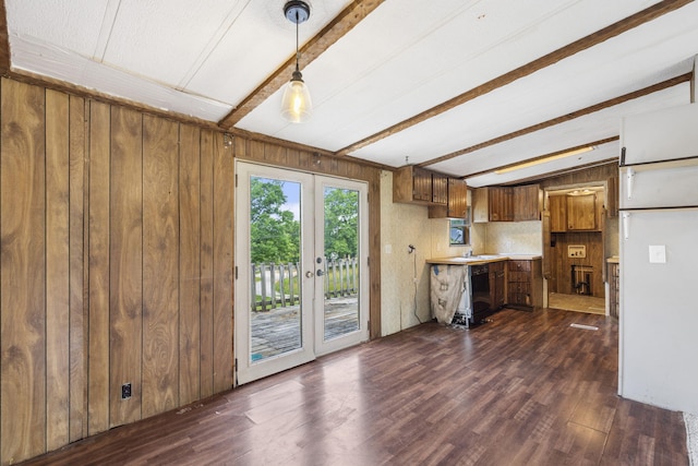 kitchen with french doors, wood walls, dark hardwood / wood-style floors, and pendant lighting