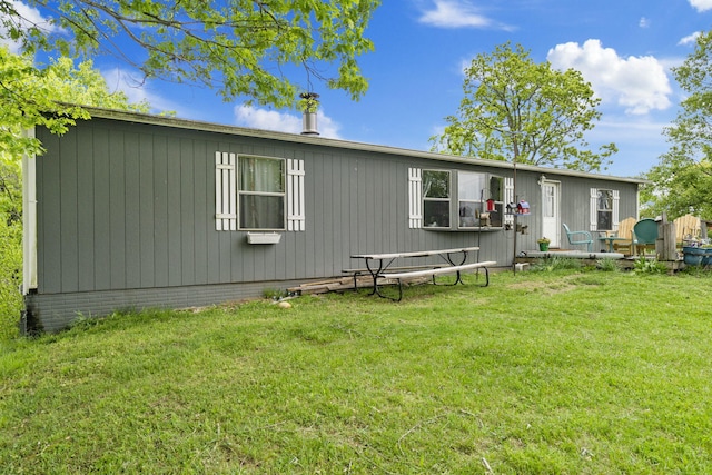 rear view of house with a yard