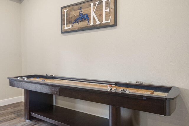 playroom featuring baseboards and wood finished floors