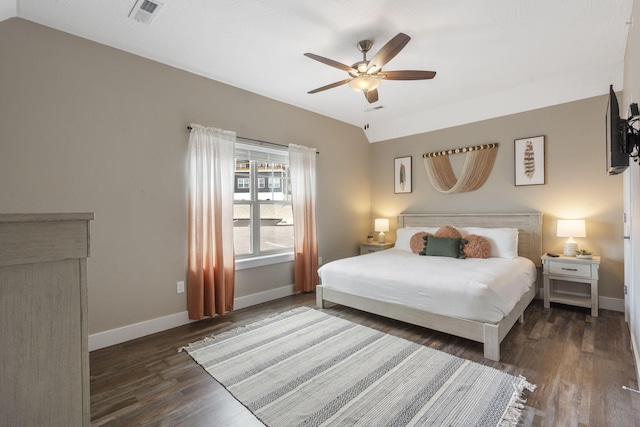 bedroom featuring baseboards, visible vents, lofted ceiling, a ceiling fan, and wood finished floors