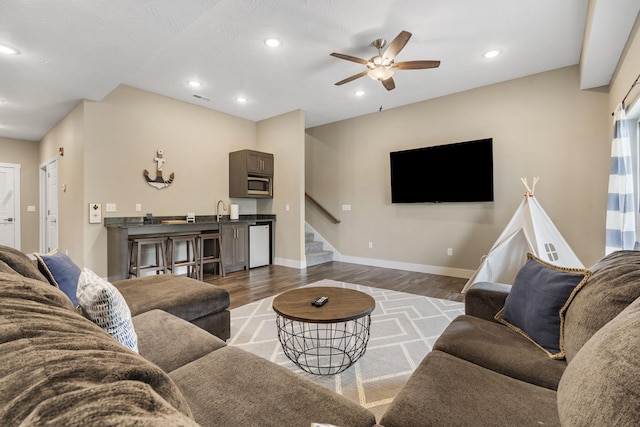living room with recessed lighting, wood finished floors, ceiling fan, and stairway