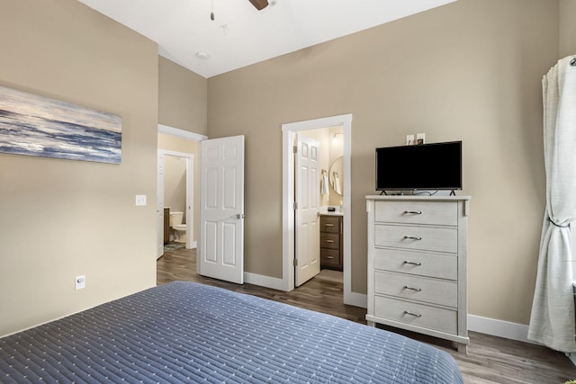 unfurnished bedroom with dark wood-type flooring, lofted ceiling, ensuite bathroom, and ceiling fan