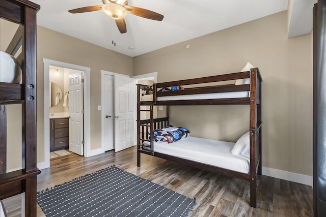 bedroom featuring ceiling fan, hardwood / wood-style flooring, and connected bathroom