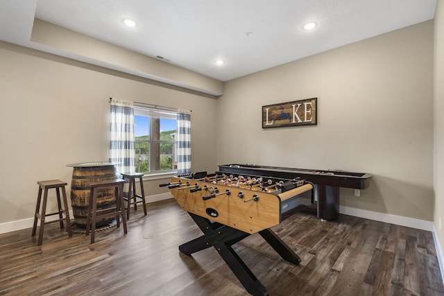 game room with dark hardwood / wood-style floors