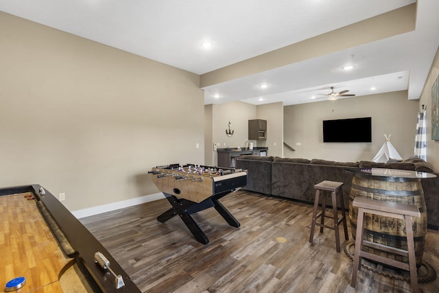 recreation room featuring baseboards, a ceiling fan, wood finished floors, and recessed lighting