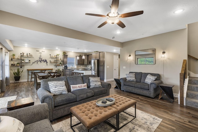 living room featuring ceiling fan and dark wood-type flooring