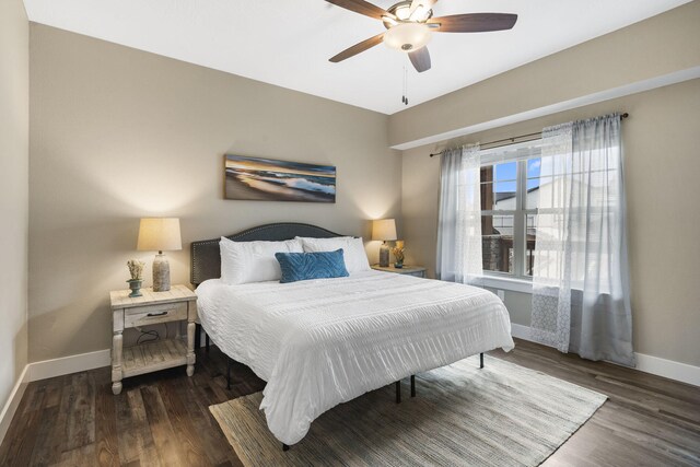 bedroom featuring wood finished floors, baseboards, and a ceiling fan