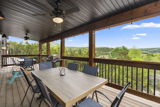 wooden terrace with grilling area and ceiling fan