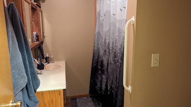 bathroom featuring vanity and curtained shower