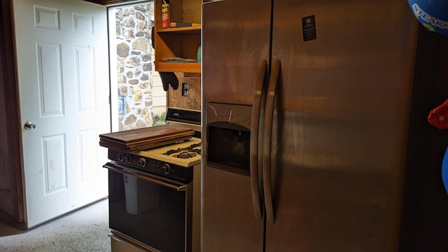 kitchen featuring stove and stainless steel fridge