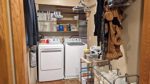 clothes washing area with hardwood / wood-style floors and separate washer and dryer