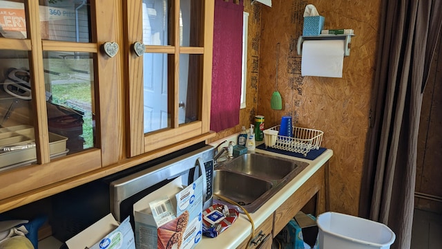 bathroom with wood walls and sink