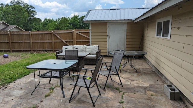 view of patio featuring an outdoor hangout area and a storage unit