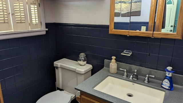 1404 6th St, Monett, MO 65708 - half bathroom featuring a wainscoted wall, a sink, and toilet