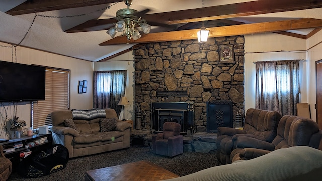 living room with carpet flooring, ceiling fan, a stone fireplace, vaulted ceiling with beams, and a textured ceiling