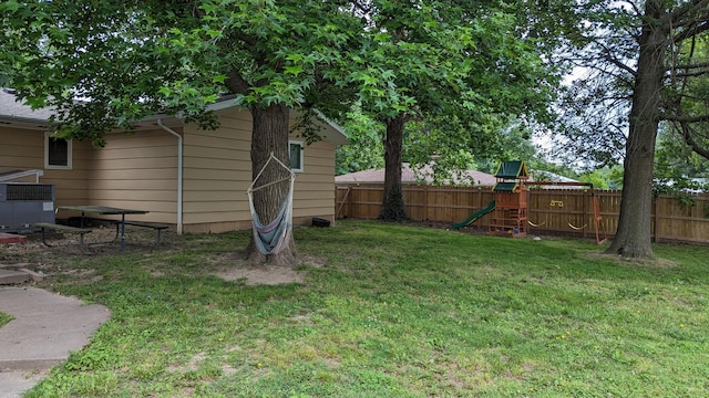 1404 6th St, Monett, MO 65708 - view of yard with a fenced backyard and a playground