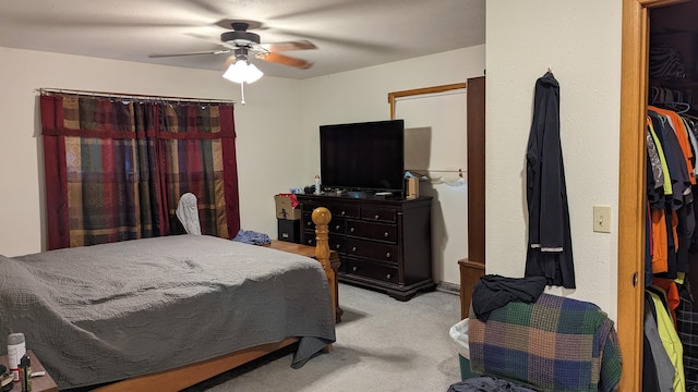 carpeted bedroom with ceiling fan and a closet