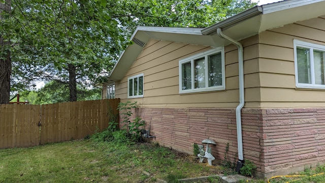 view of side of property with a yard