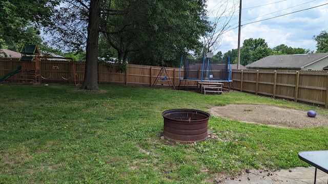 1404 6th St, Monett, MO 65708 - view of yard with a fenced backyard, a playground, and a trampoline