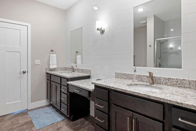 bathroom featuring walk in shower and vanity