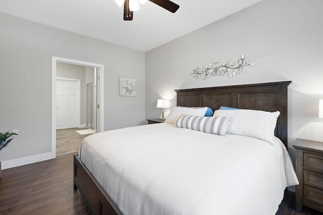 bedroom with connected bathroom, dark wood-type flooring, and ceiling fan