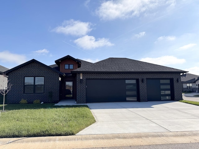 prairie-style house with a garage and a front yard