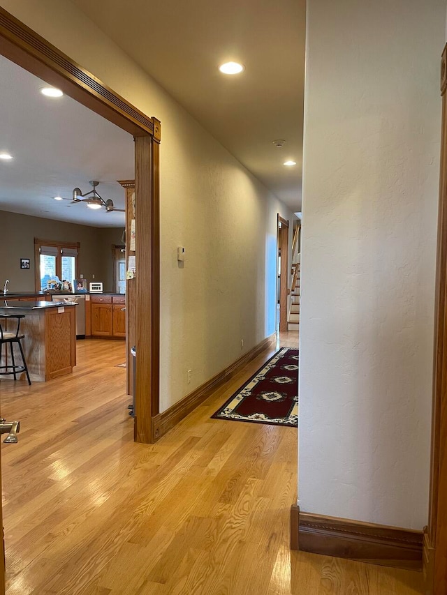 hall with light hardwood / wood-style floors