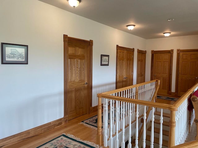 corridor with hardwood / wood-style flooring