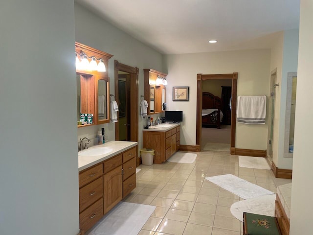 bathroom with tile patterned flooring, a shower with door, and vanity