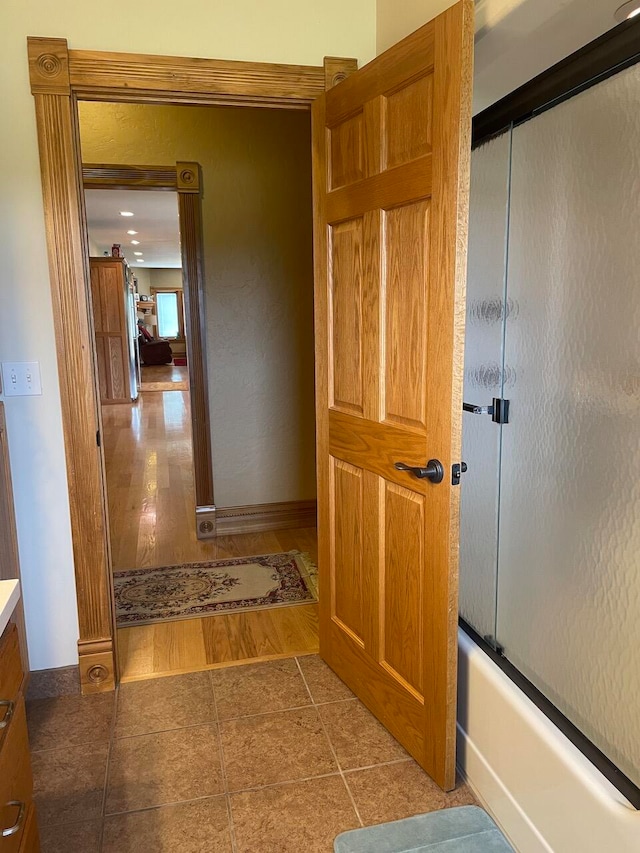 hallway with hardwood / wood-style floors