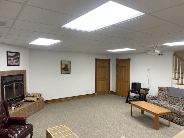 1179 County Road 1050, Willow Springs, MO 65793 - living room with a glass covered fireplace, baseboards, carpet flooring, and a drop ceiling