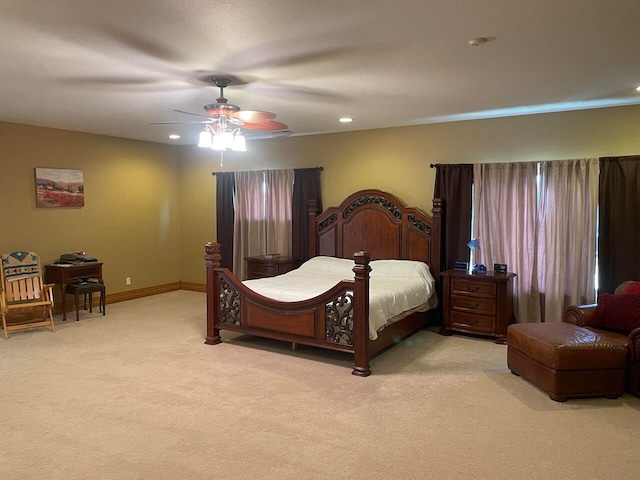 bedroom featuring light colored carpet and ceiling fan