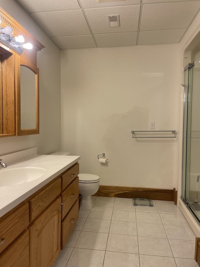 1179 County Road 1050, Willow Springs, MO 65793 - bathroom with tile patterned floors, a paneled ceiling, a shower with shower door, toilet, and vanity