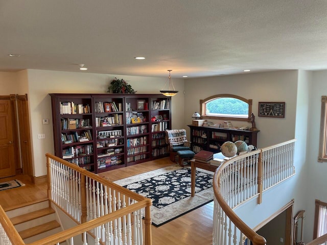 living area with light hardwood / wood-style flooring and a textured ceiling