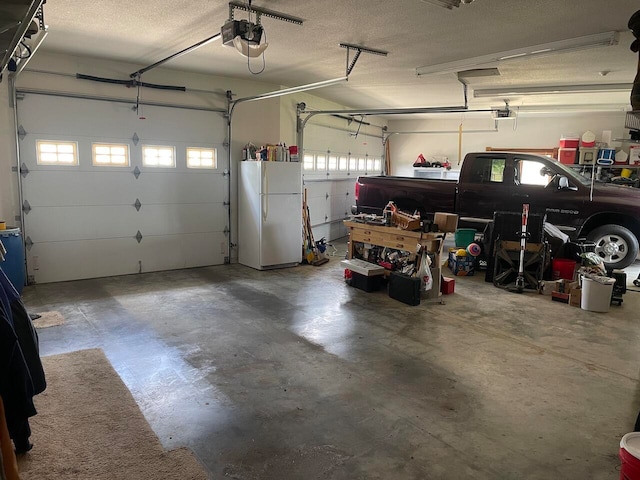 garage featuring a garage door opener and white fridge