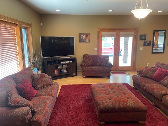 living room featuring french doors and light hardwood / wood-style flooring