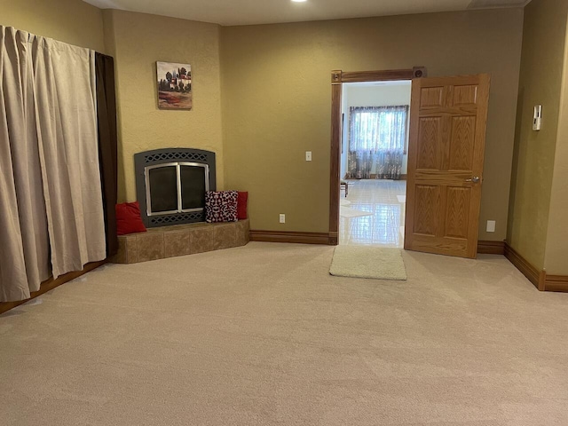 1179 County Road 1050, Willow Springs, MO 65793 - unfurnished living room featuring a tile fireplace, carpet flooring, and baseboards